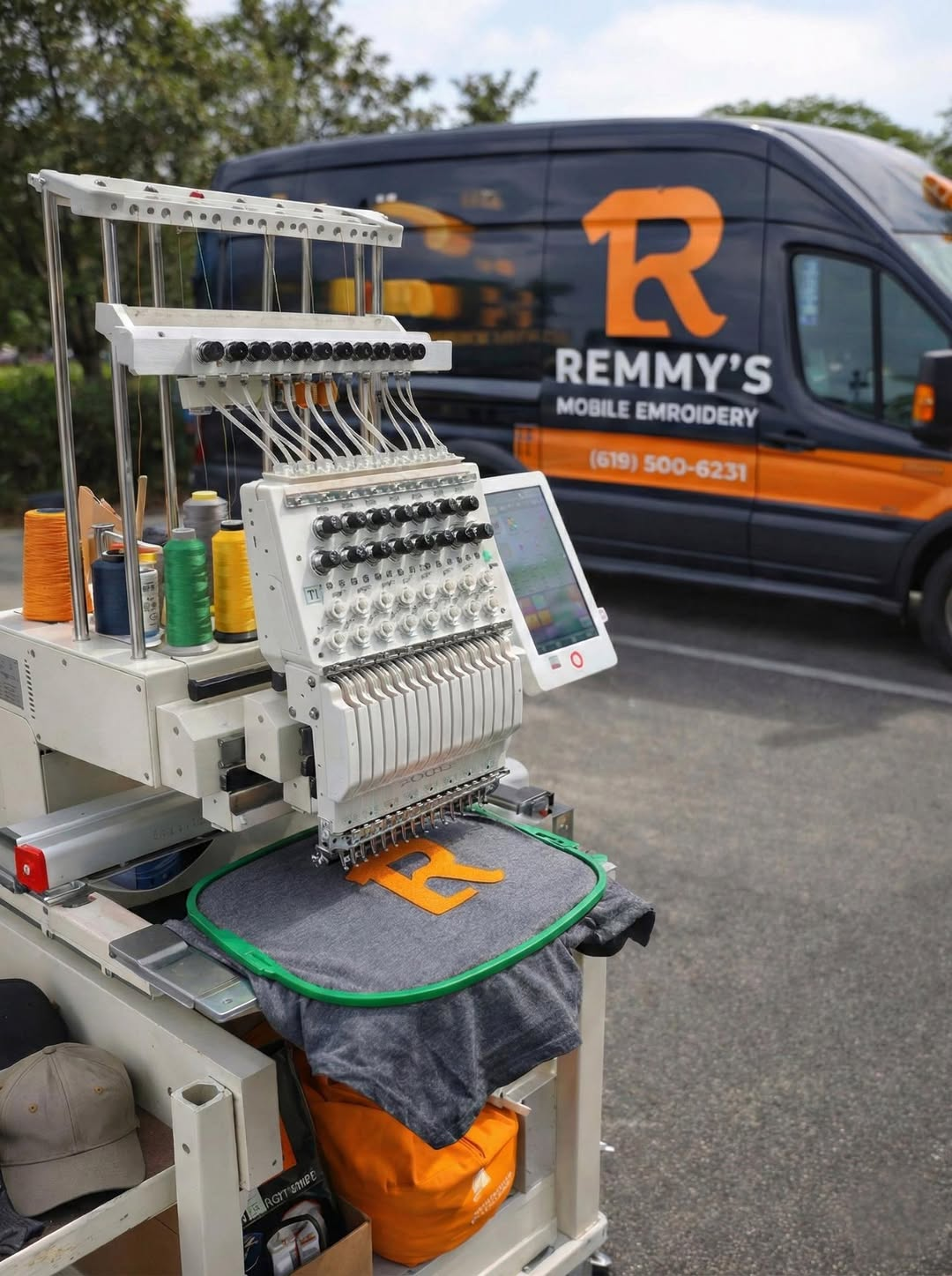Remmy’s embroidery machine set up in front of the Remmy’s Mobile Embroidery van