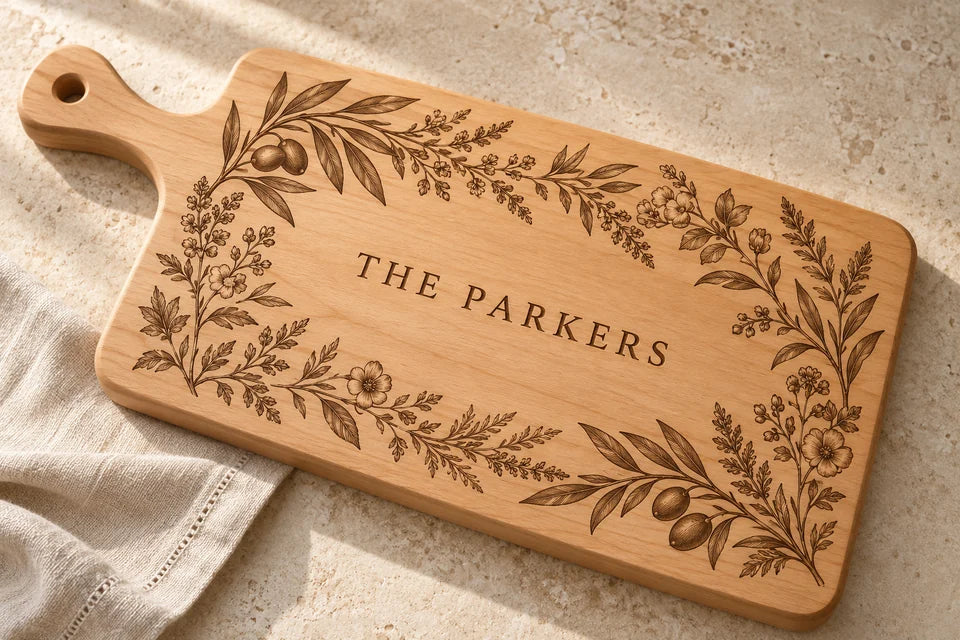 Maple serving board with botanical engraving and THE PARKERS lettering.
